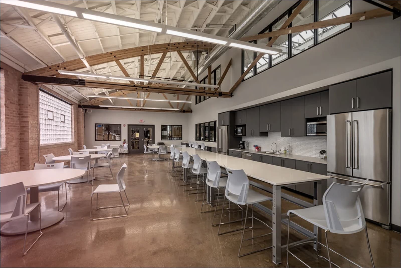 Commercial break room buildout with exposed truss ceiling completed by SNV Contracting Group